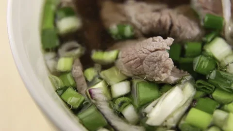 Boiled beef, green onions, red onions, broth. Fo Beau soup. Close-up. Video stock 233058130
