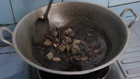Boiled black squid soup in a pot. squid ink soup. preparing food in the pan Stockbeeldmateriaal 239000057