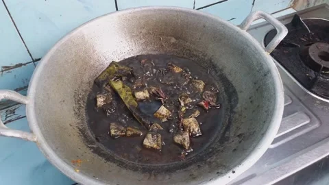 Boiled black squid soup in a pot.squid ink soup.Asian Indonesia traditional food Vídeo Stock 238917177