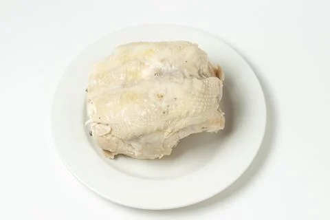 Boiled chicken breast on a white background. Diet meat on a white plate.  Stock Photos