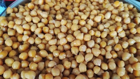 Boiled chickpeas are  falling down from above 2 Stock Footage 196845100