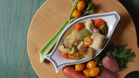 Boiled cod with potatoes, celery and carrots. Close-up of plate ready to cook Stock Footage 168484866