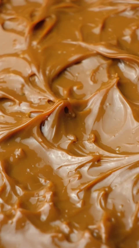 Boiled condensed milk texture or dulce de leche background. Stock Footage 331458040