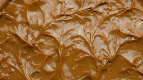 Boiled condensed milk texture or dulce de leche background top view. Stock Footage 332011261