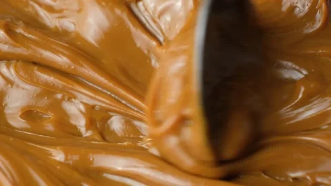 Boiled condensed milk texture or dulce de leche background Stock Footage 332658286