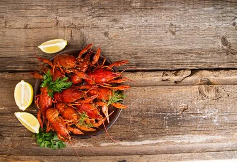 Boiled cooked crayfish crawfish ready to eat onold rustic wooden background.  Stock Photos