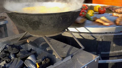 Boiled corn and a rotary grill nearby. Video stock 124632042