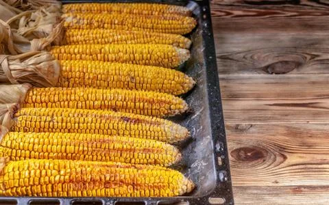 Boiled corn on the cob on a rustic table. Close-up. Stock Photos