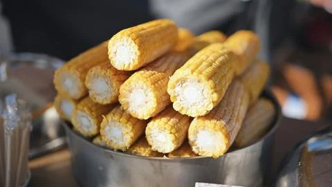 Boiled corn cobs preparing as street food for cultural festival attendees Stock Photos
