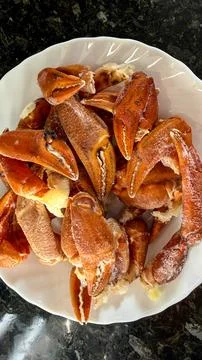 Boiled crab claws on a plate Stock Photos
