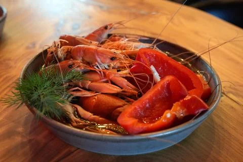 Boiled crawfish served with red bell pepper and fresh dill in a gray ceramic  Stock Photos