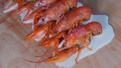 Boiled crayfish lie on the table with grass close up Stock Footage 179988561