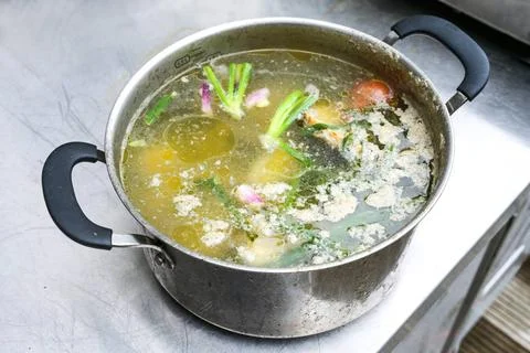 Boiled down broth cooked from vegetable scraps and poultry trimmings with ... Stock Photos