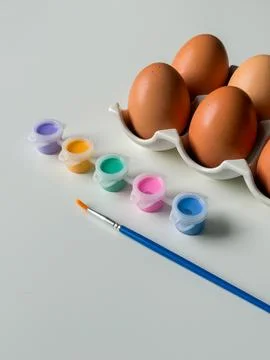 Boiled Easter eggs with paints before decorating on white background close .. Stock Photos