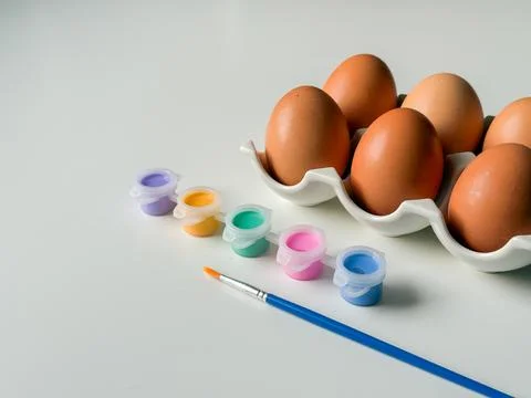 Boiled Easter eggs with paints before decorating on white background close .. Foto stock