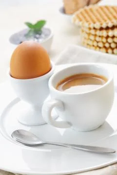 Boiled egg and coffee for breakfast Stock Photos