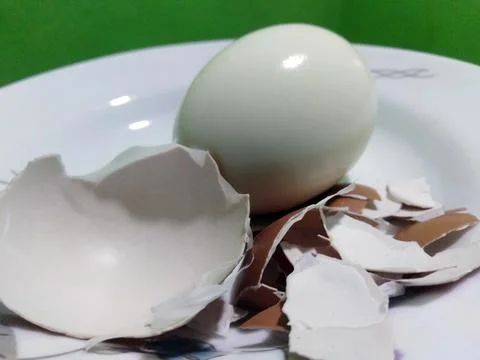 Boiled egg and eggshell on a white plate. Healthy nutritional food Stock Photos