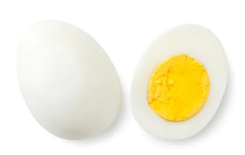Boiled egg and half top view close-up on a white. Isolated Stock Photos