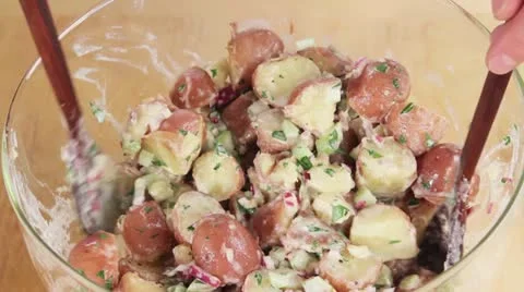 Boiled egg being added to potato salad Stock Footage 24656048