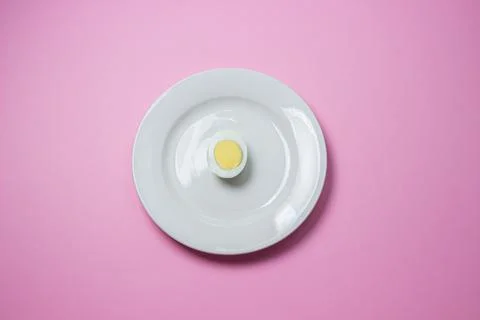 A boiled egg cut in half on a plate. Healthy breakfast. Stock Photos