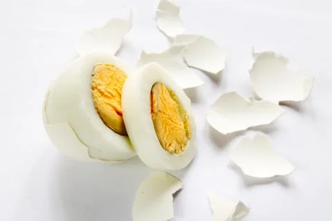 Boiled egg in a cut with a shell on white background Stock Photos