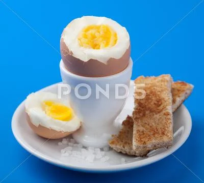 Boiled egg in egg cup Stock Photos