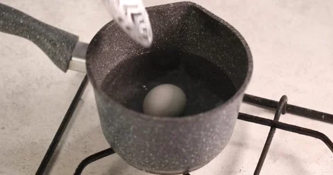 Boiled egg in grey pot take off Stock Footage 194104347