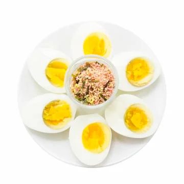 Boiled egg half cut snack with topping shot top view Foto stock