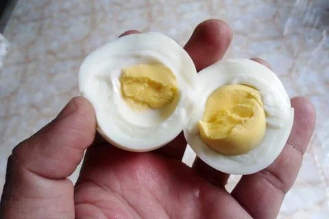Boiled egg on hand. Boiled egg ready for the breakfast meal Stock Photos