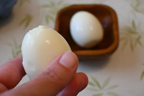 Boiled egg held in hand close-up Фото