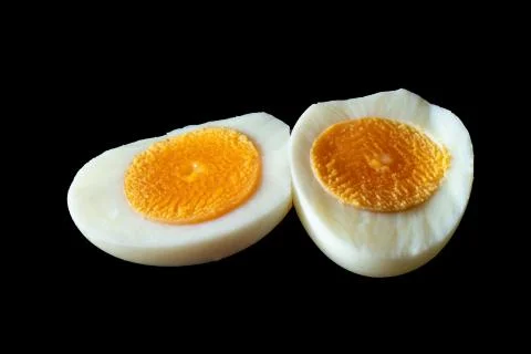 Boiled egg isolated on Black background. Boiled sliced chicken eggs isolated. Stock Photos
