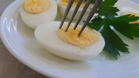 Boiled egg, parsley on a plate Stock Footage 114872054