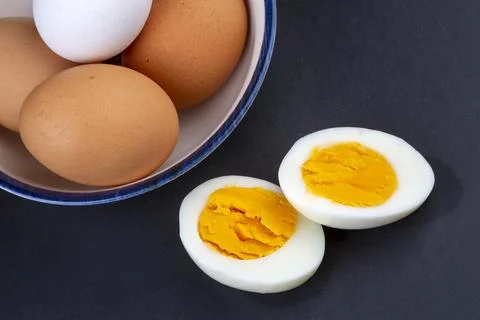 Boiled egg served on a black background Stock Photos