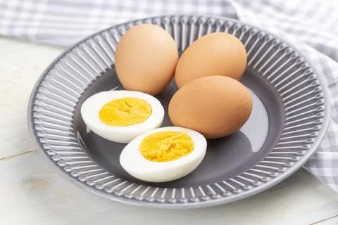 Boiled egg served on a black background Stock Photos