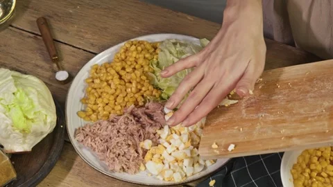 The boiled egg is sliced into pieces and placed on a cutting board, adding a Stock Footage 301786857