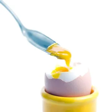 Boiled egg with a spoon Stock Photos