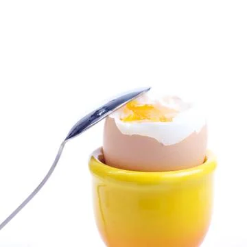 Boiled egg with a spoon Stock Photos