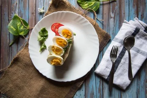 Boiled eggs on bun bread in a plate Stock Photos