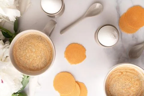 Boiled eggs in ceramic egg cups and two cups of coffee on background of Stock Photos