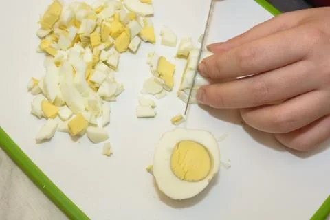 Boiled eggs cut on a board Stock Photos