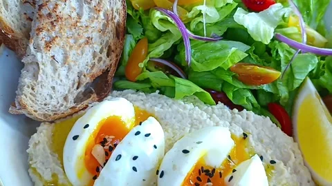 Boiled eggs with hummus and bread Stock Footage 261050608