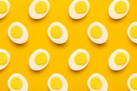 Boiled eggs pattern on yellow background Stock Photos