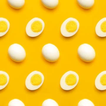 Boiled eggs pattern on yellow background Stock Photos
