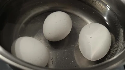 Boiled eggs in a saucepan on fire. Cooking eggs Stock Footage 296737592