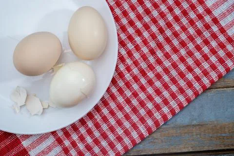 Boiled eggs with shell on the white plate Stock Photos