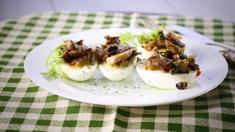 Boiled eggs stuffed with mushrooms and spices in a plate . Stock Footage 267912252