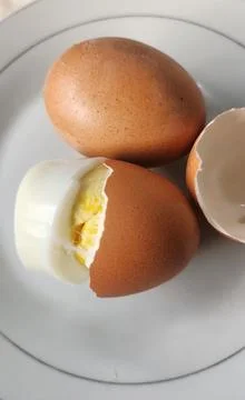 Boiled eggs with their shells peeled, ready for breakfast Stock Photos