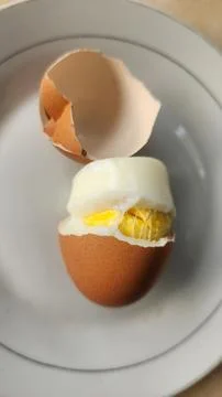 Boiled eggs with their shells peeled, ready for breakfast Stock Photos
