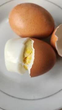 Boiled eggs with their shells peeled, ready for breakfast Stock Photos