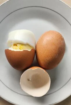 Boiled eggs with their shells peeled, ready for breakfast Stock Photos